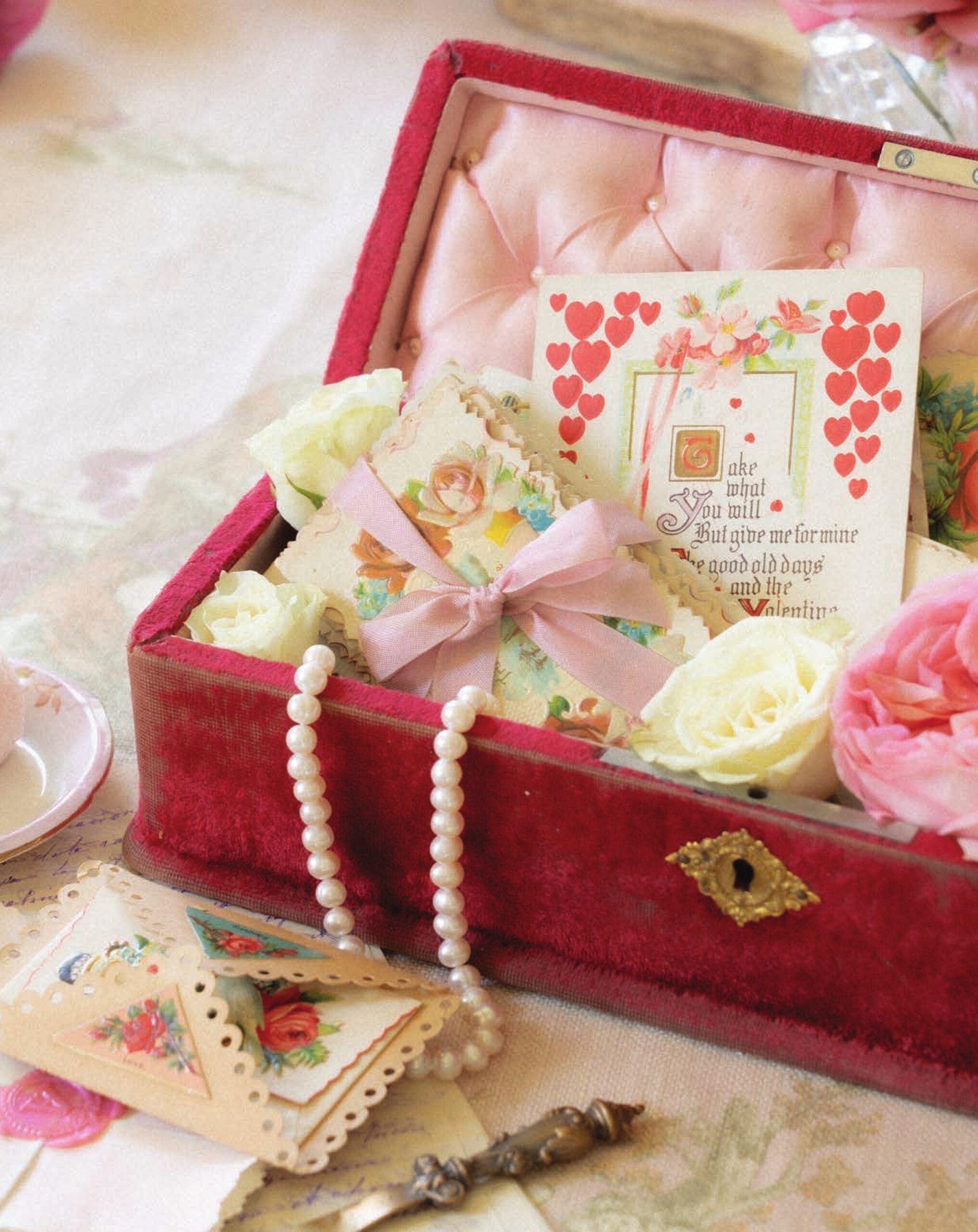 A breathtaking rendition of a pocket watch chair, designed to hold the timepiece when not in use, adds diminutive charm to a display of Valentines, with one handmade card boasting three-dimensional splendor.