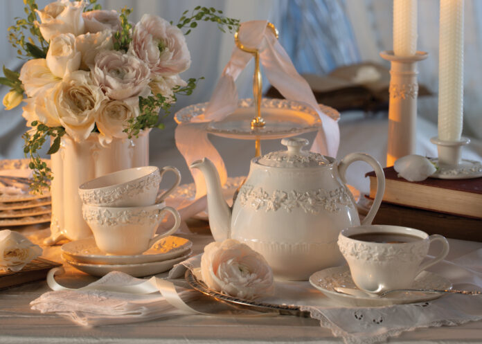 A white teapot and white teacups