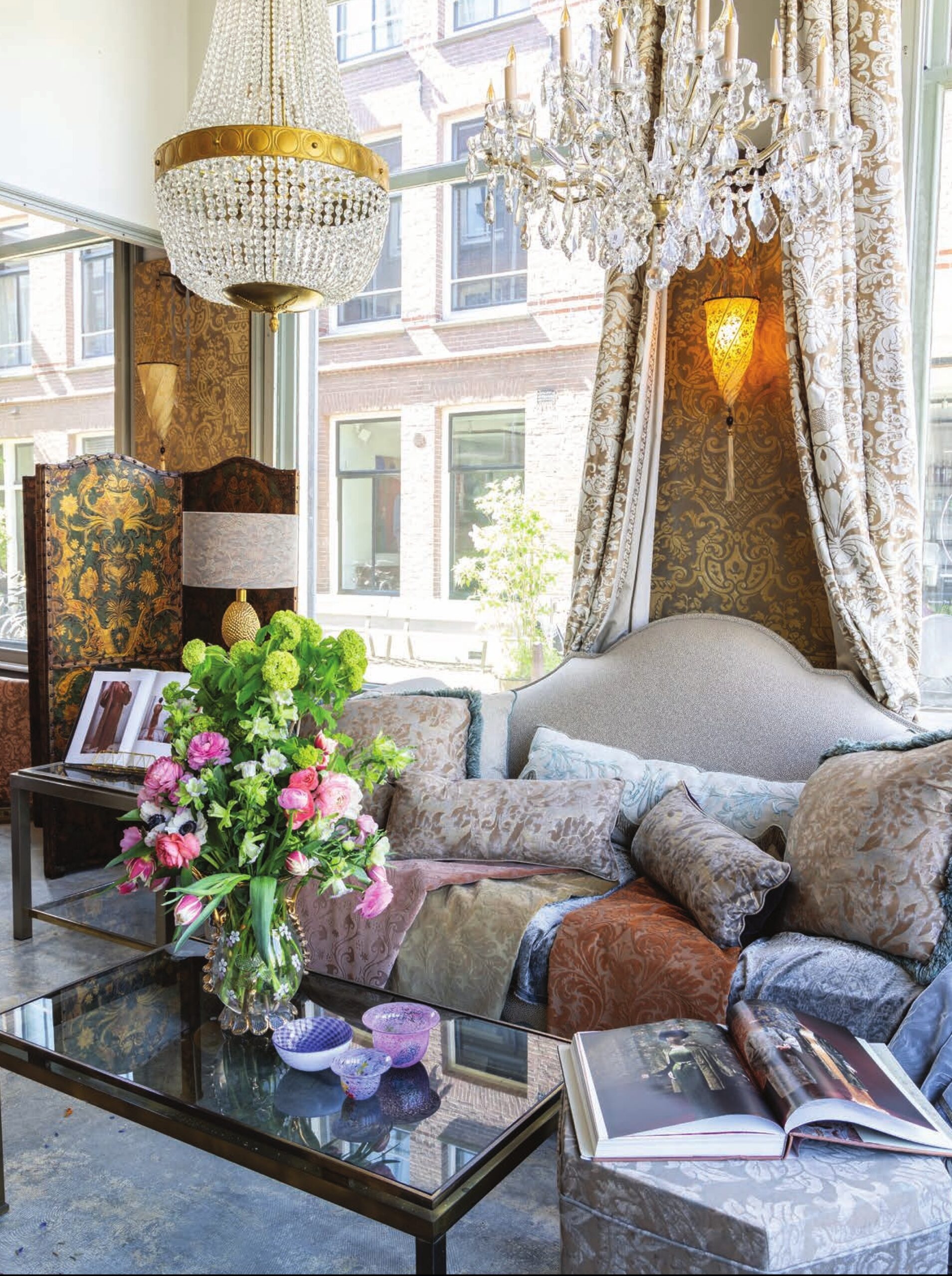 Elegant fabrics drape over a sofa in Rho Interiors, Amsterdam.