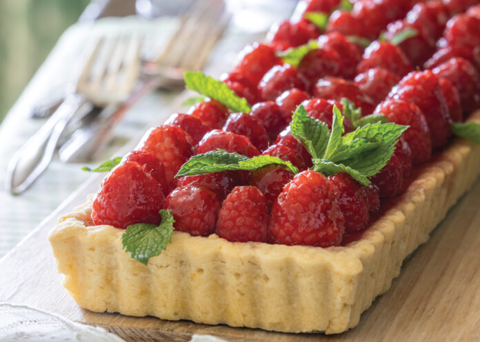 Raspberry tart on a wooden board