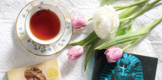 Books with tea cup and tulips