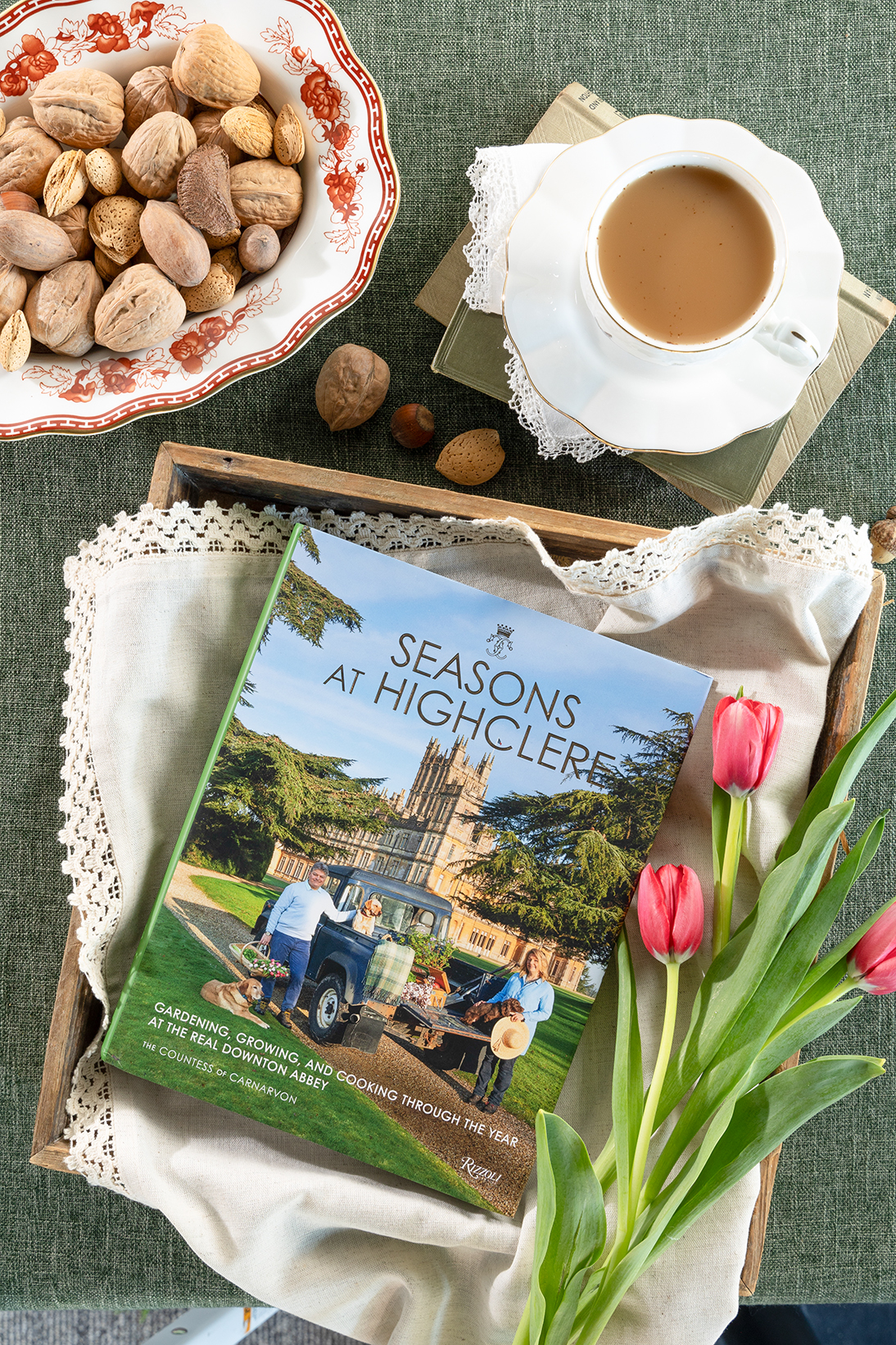 Seasons at Highclere book next to pink tulips