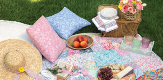 Colorful quilt laid out with picnic accessories