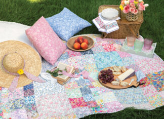 Colorful quilt laid out with picnic accessories