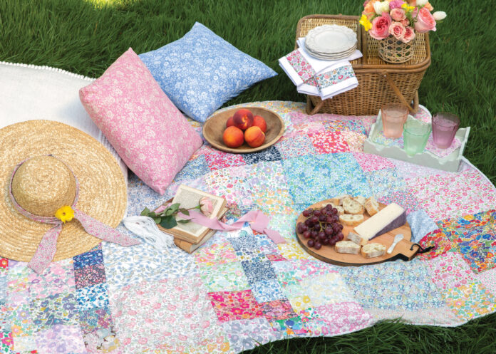 Colorful quilt laid out with picnic accessories