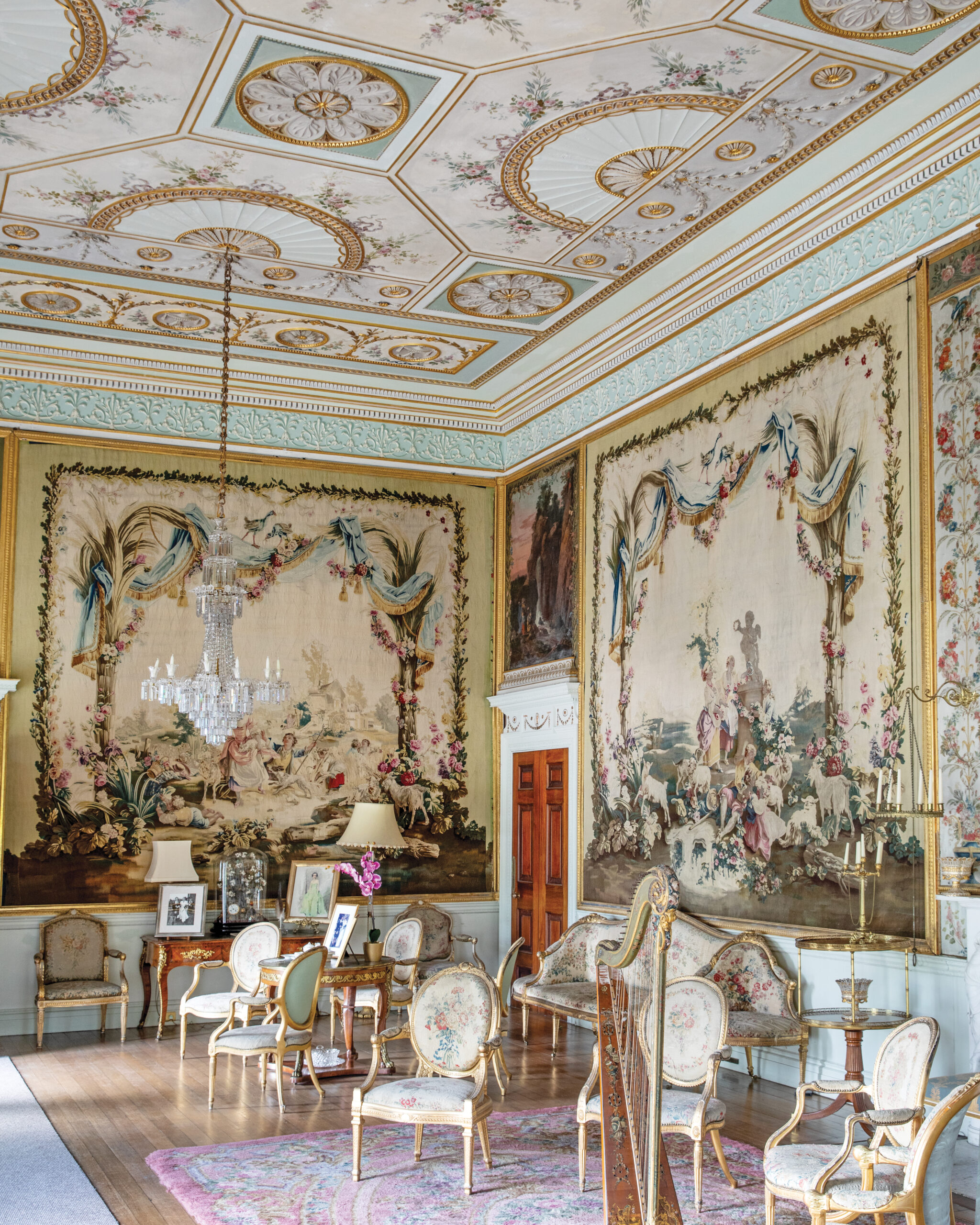 Ornate drawing room with Parisian tapestries, chairs, and a harp 