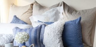 A bed piled high with lofty pillows and layered in luxury often paves the way to a journey into dreamland.