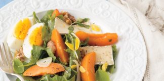Walnuts, fennel, and soft-boiled eggs lend unexpected textural elements to a bed of baby arugula in Apricot-and-Brie Salad.