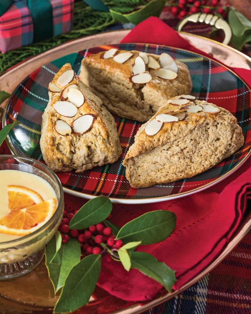Resting atop a red-and-green plaid plate, our Gingerbread Almond Scones await indulgence.