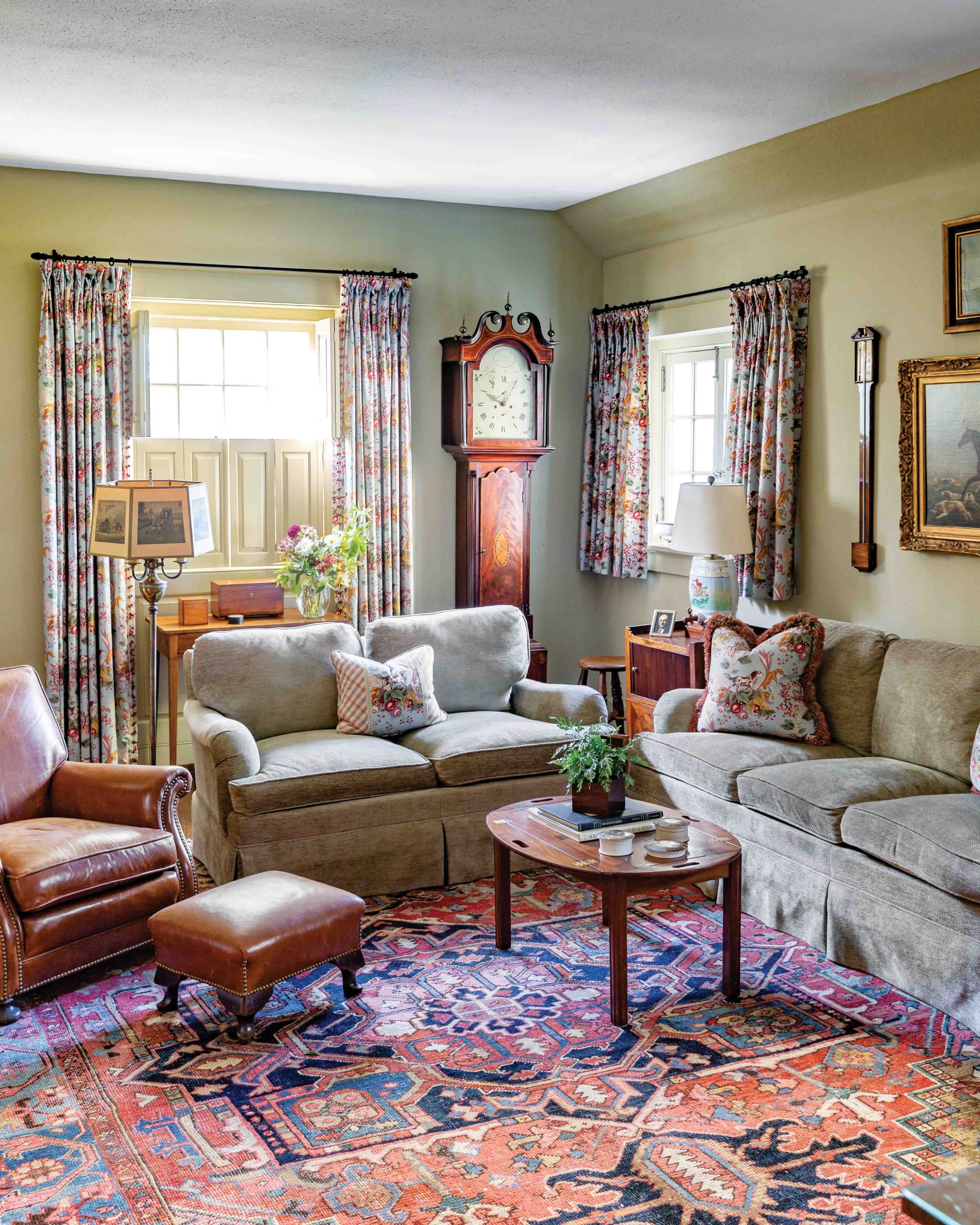 A grandfather clock, barometer, and cozy patterns grace this green sitting room.