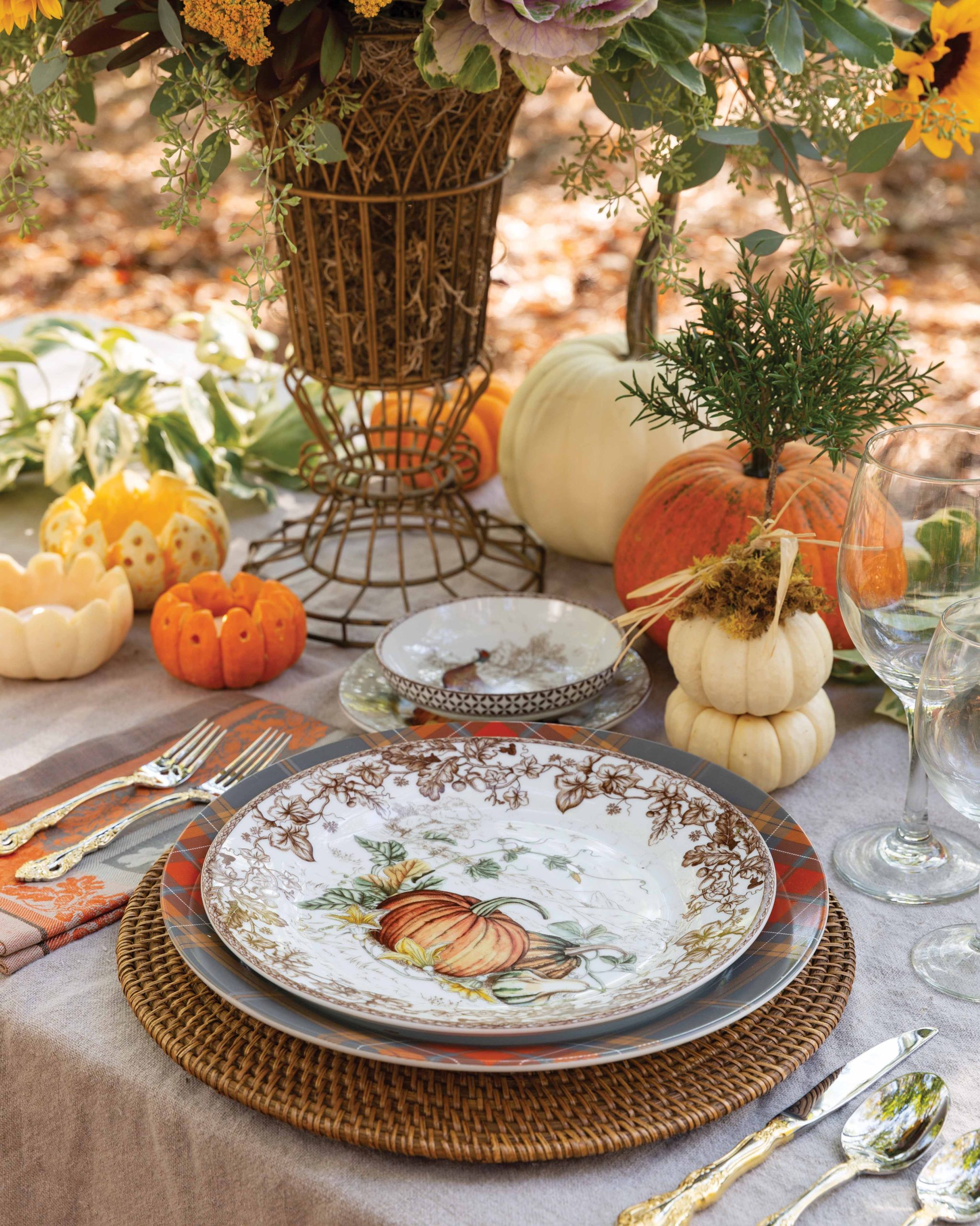 A single place setting is surrounded by pumpkins, even on the china pattern itself.