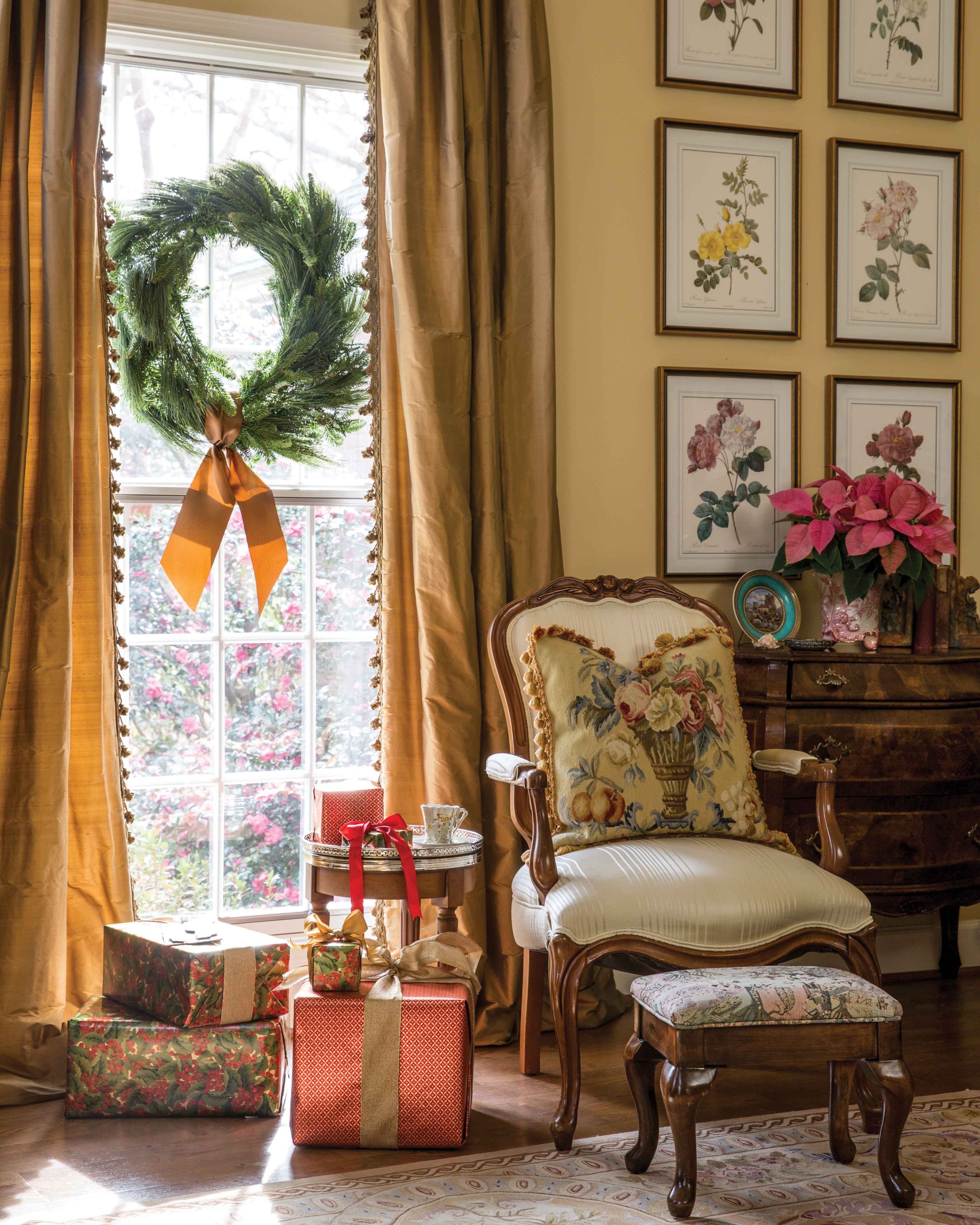 Beside a window with a simple wreath, a charming chair and sweetly wrapped presents sit peacefully.