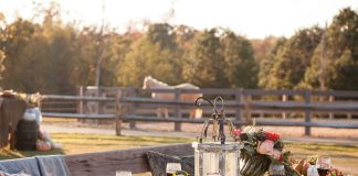 Table for All Seasons: arranged outside the stables, a romantic table is laden with colorful flowers, lush greenery, and Julie Wear china.