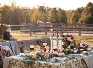 Table for All Seasons: arranged outside the stables, a romantic table is laden with colorful flowers, lush greenery, and Julie Wear china.