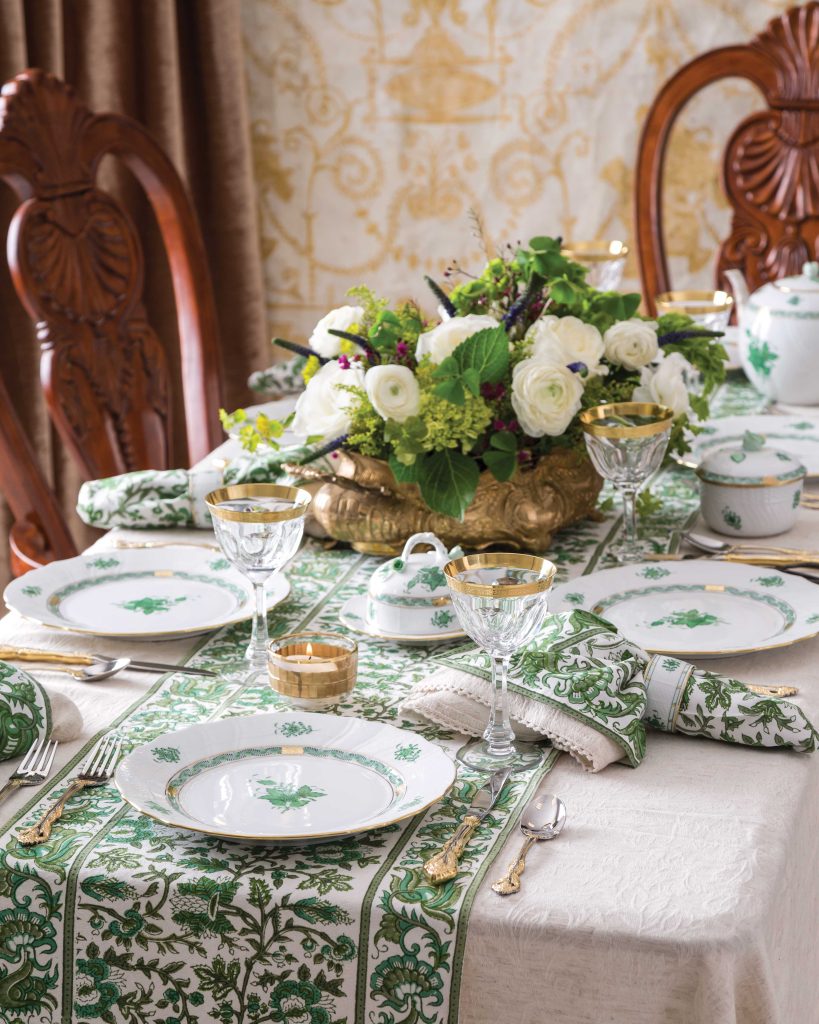 At a table laden with green and white linens, gilt crystal, and fresh flowers, a Saint Patrick’s Day feast awaits.