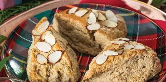 Resting atop a red-and-green plaid plate, our Gingerbread Almond Scones await indulgence.