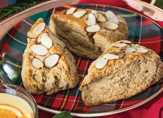 Resting atop a red-and-green plaid plate, our Gingerbread Almond Scones await indulgence.