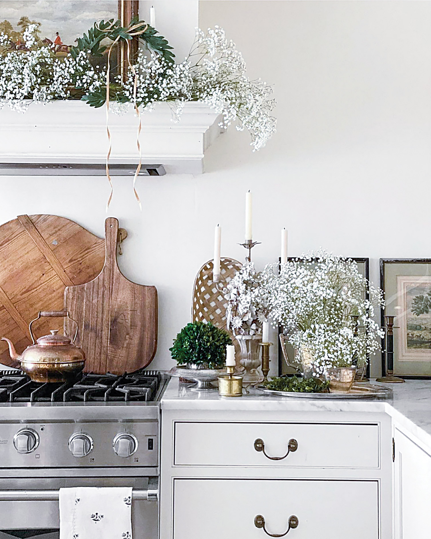  Greenery and baby’s breath decorate the range hood and countertop at Tallwood Country House.