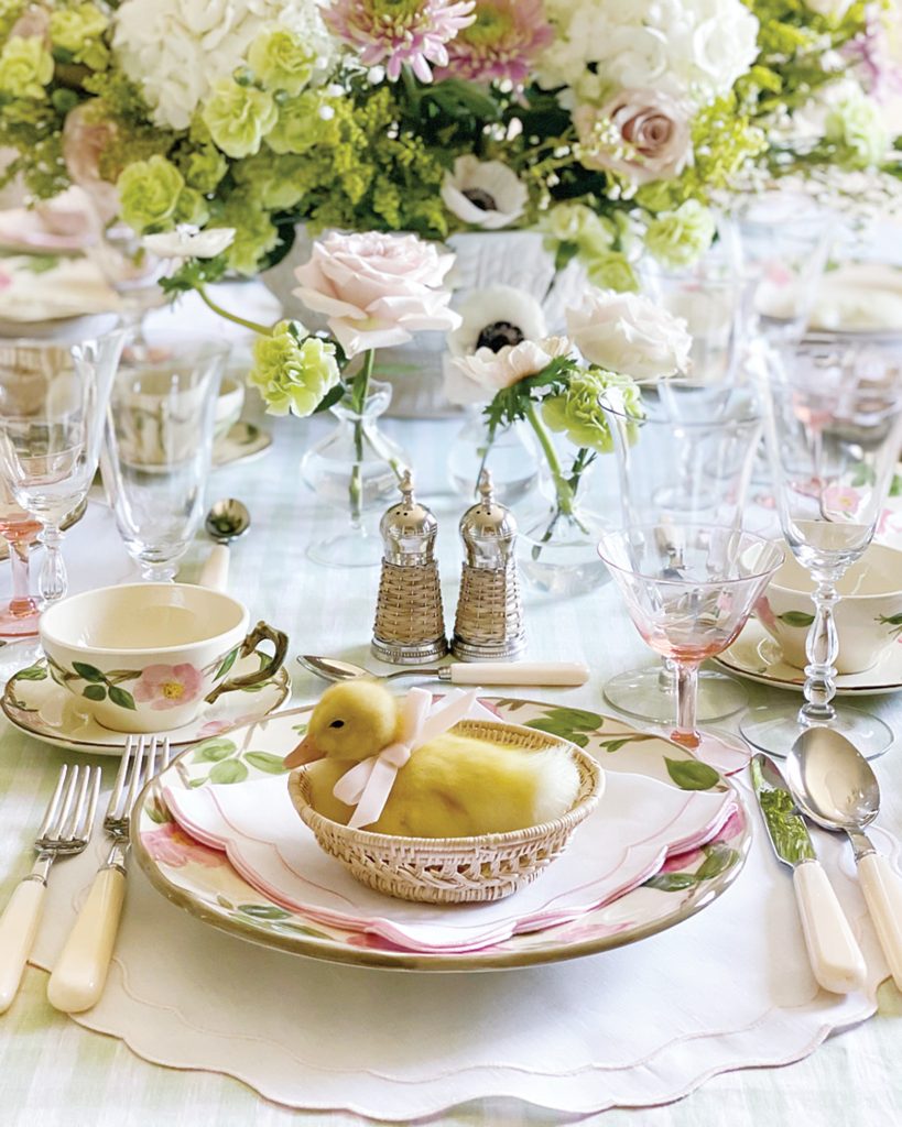 Jenny Bohannon’s tabletop is dressed in green and pink finery for springtime, but the sweetest part is the little duckling sitting in a wicker bowl with a pink ribbon tied around its neck.