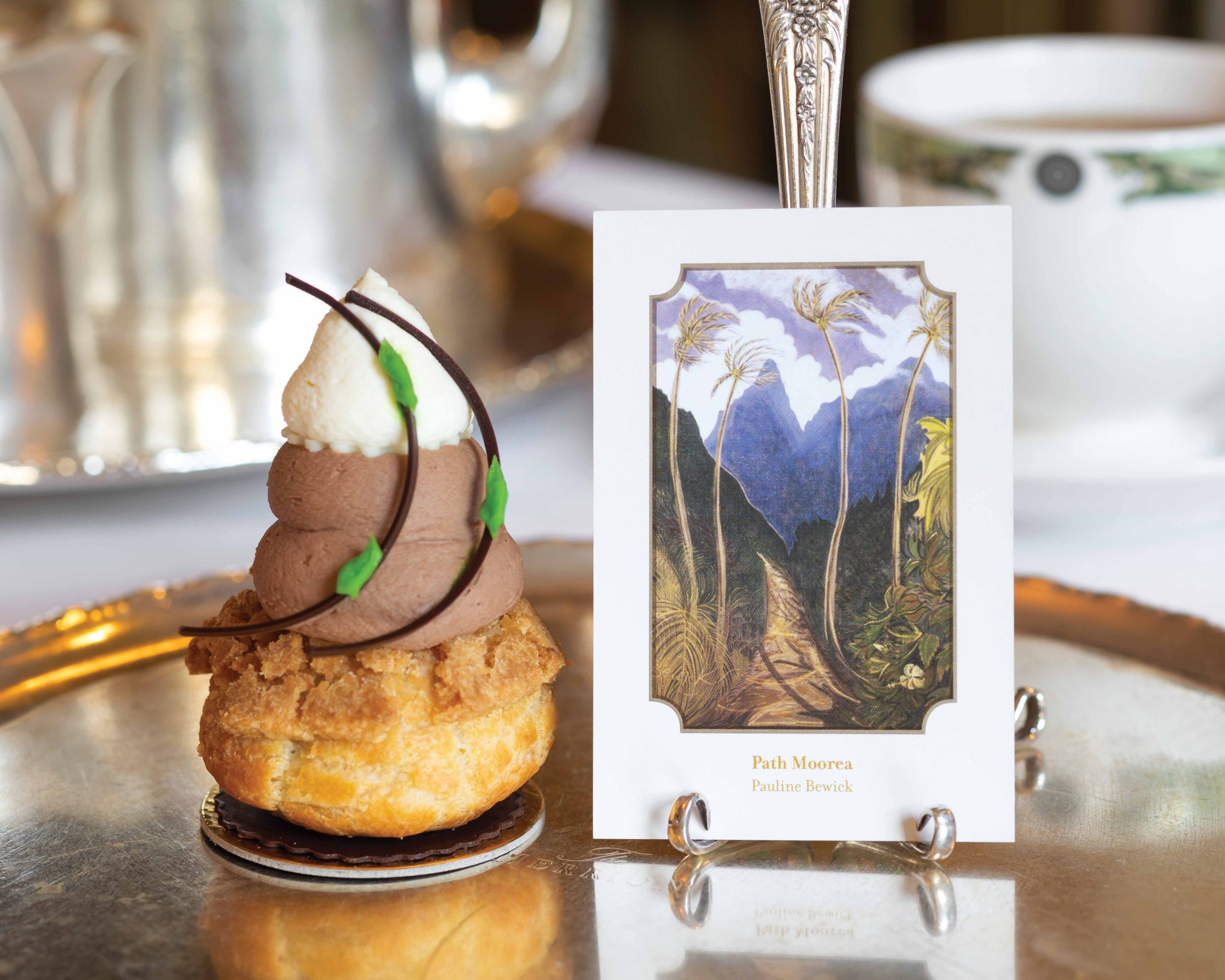 A unique pastry is displayed alongside a card depicting the painting after which the dish was designed.