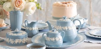 Blue-and-white Wedgwood Queen’s Ware pieces are beautifully scattered atop the table.