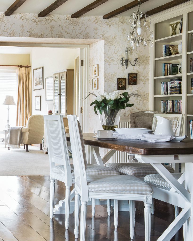 This airy dining room boasts quaint bookshelves and also has a bright view through to the living room.