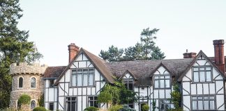 This half-timber-style home bears some architectural resemblance to a castle in addition to an English cottage.