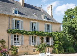 The east wing of the château is draped in wisteria vines.