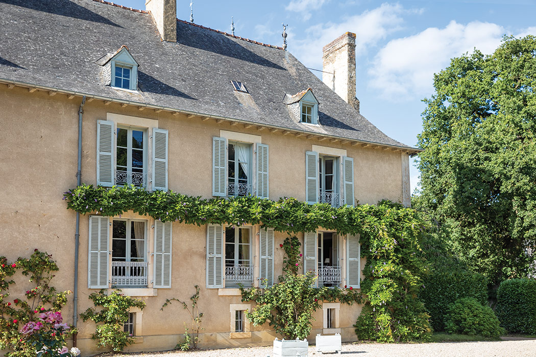 The east wing of the château is draped in wisteria vines.