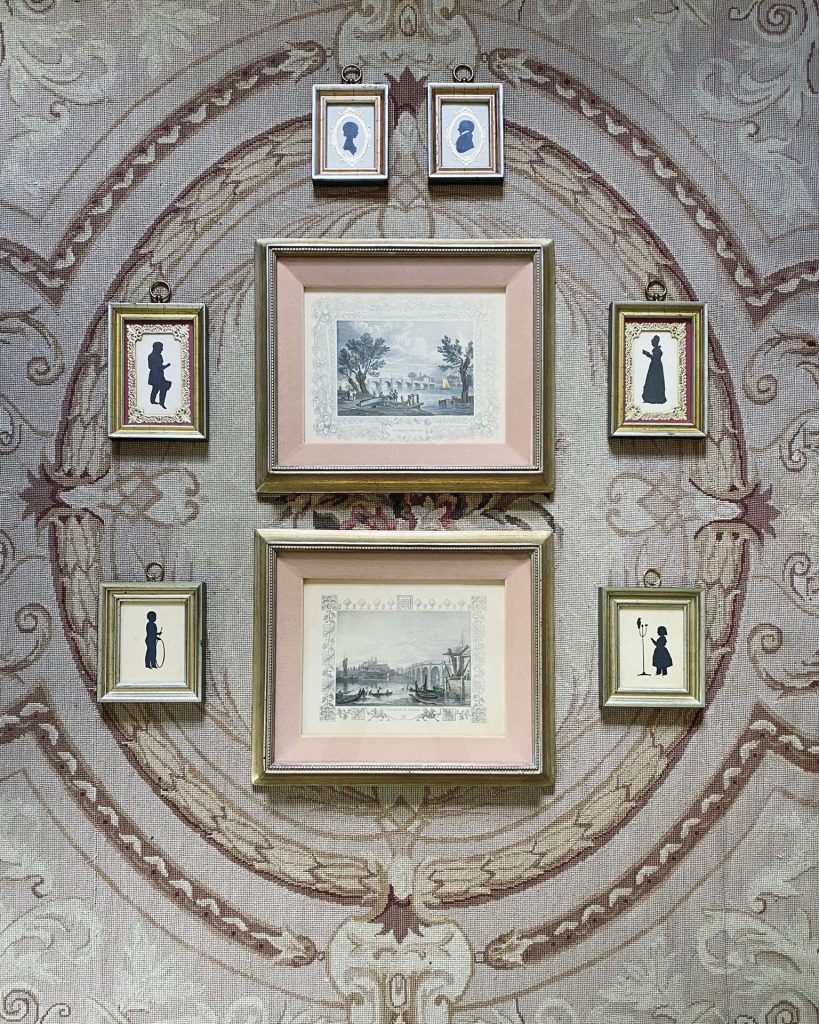 Jenny Bohannon creates a gallery of framed art prints by stacking two large pieces and surrounding the pair with six smaller pieces.