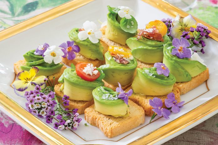 Placed atop a gilt-edged plate, Mini Avocado Toasts feature the brilliant green ingredient in all its’ freshness.