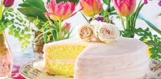 A porcelain cake tray displays this yellow treat iced in pale rose color.