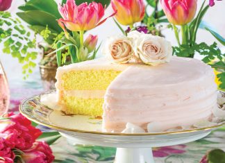 A porcelain cake tray displays this yellow treat iced in pale rose color.