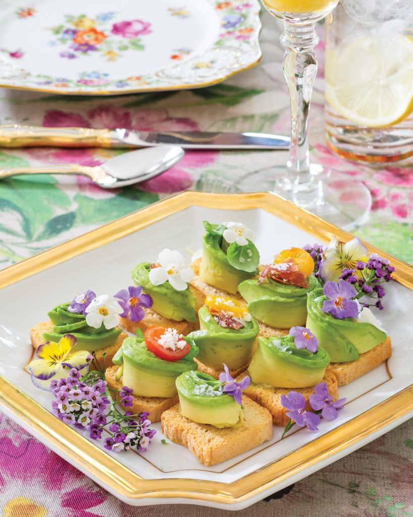 Placed atop a gilt-edged plate, Mini Avocado Toasts feature the brilliant green ingredient in all its’ freshness.