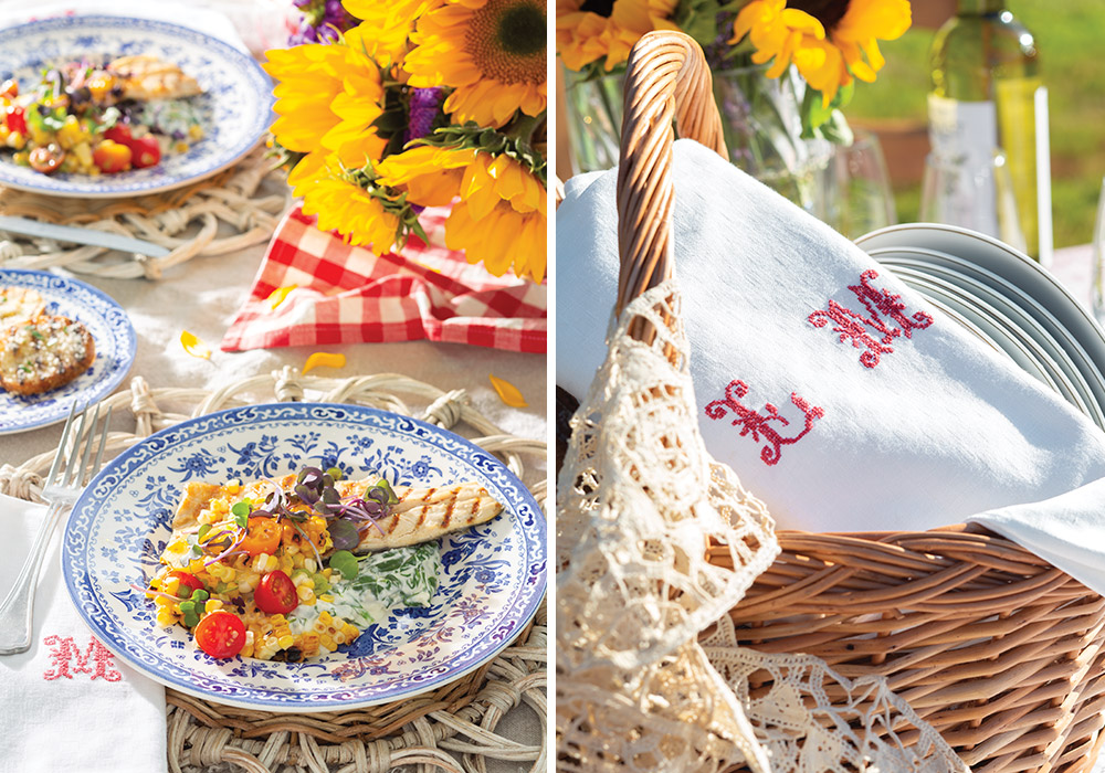 Fresh ingredients top the blue-and-white plates used in this summer setting, while a wicker basket holds the linens carried to the outdoor soiree.