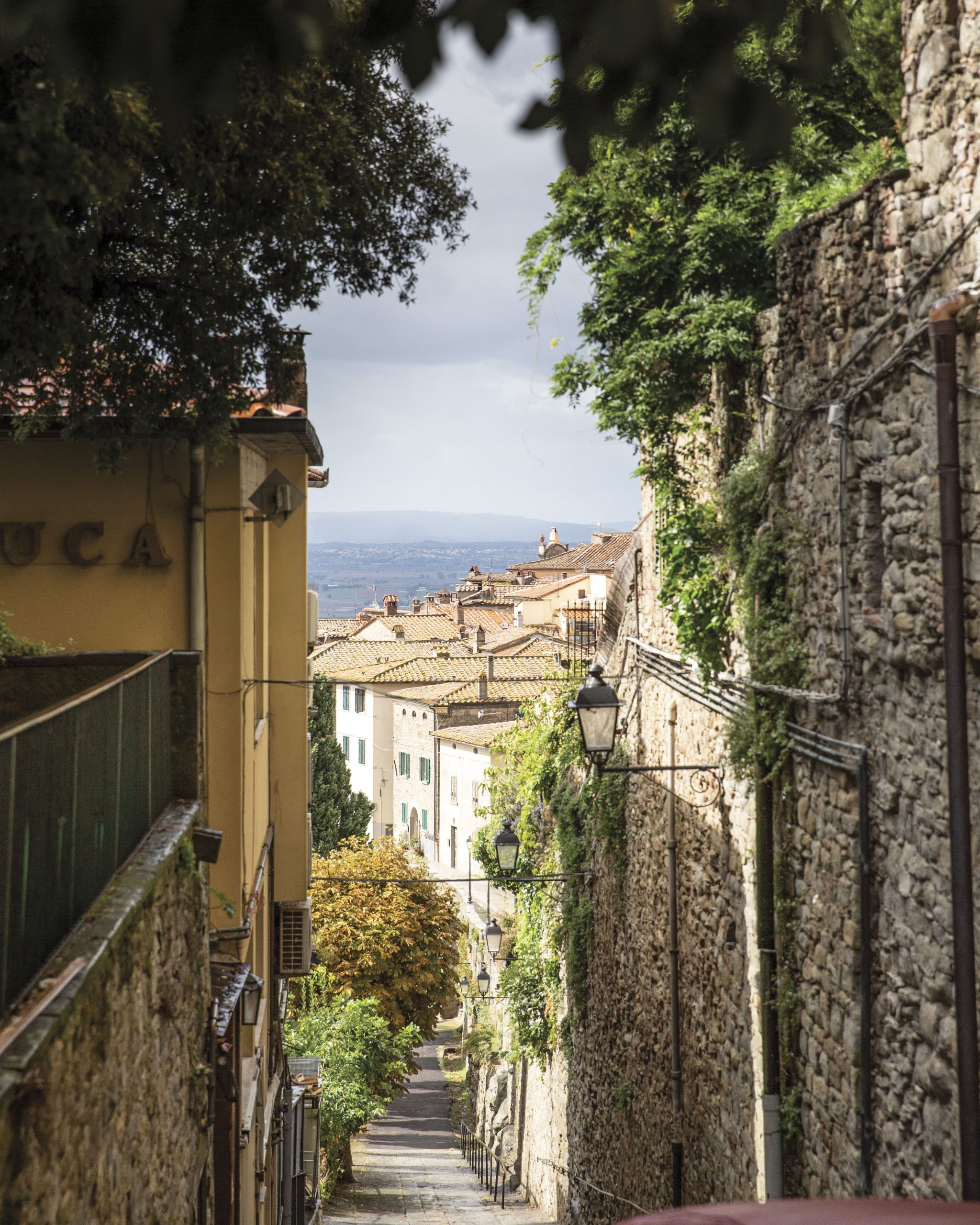 Viewed from the top of a hill, this street is lined with stone buildings and offers a stunning glimpse of the Italian city.