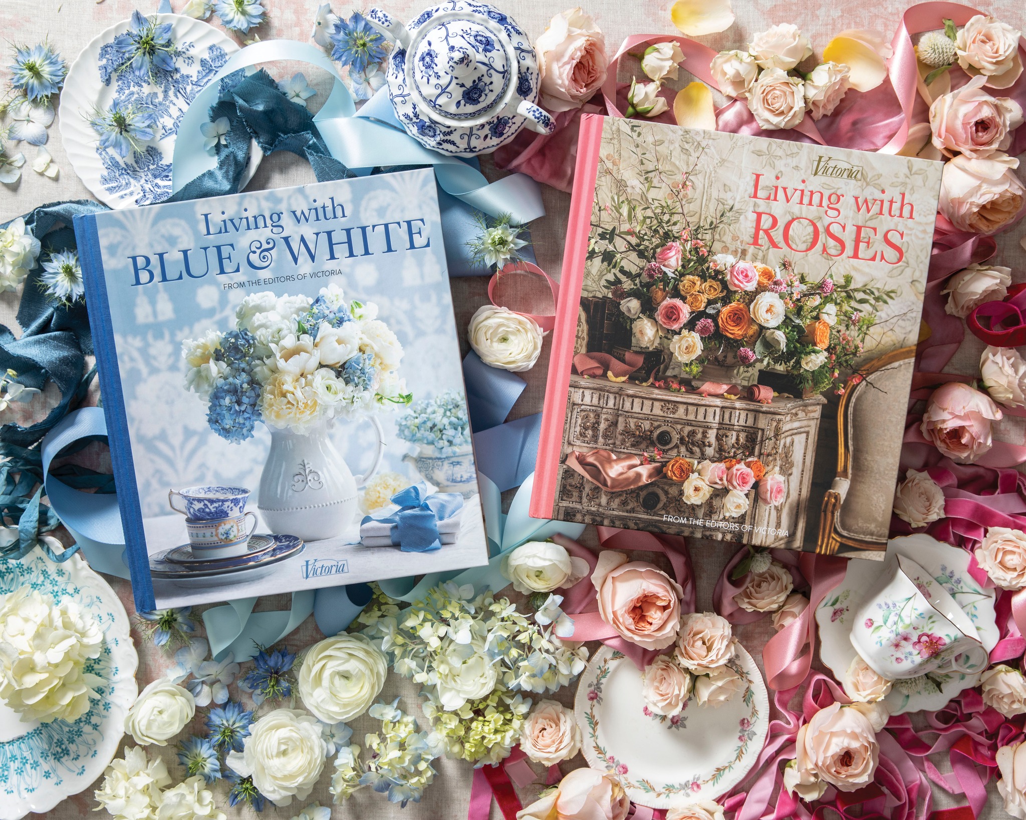 Our pair of hardcover volumes from this series, Living with Blue & White and Living with Roses rest atop flower petals and porcelain trinkets in their respective color schemes.