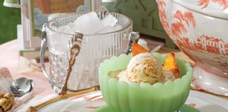 Fresh peach slices top scoops of Peaches Foster Ice Cream.