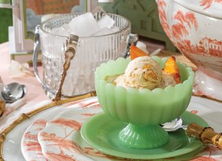 Fresh peach slices top scoops of Peaches Foster Ice Cream.