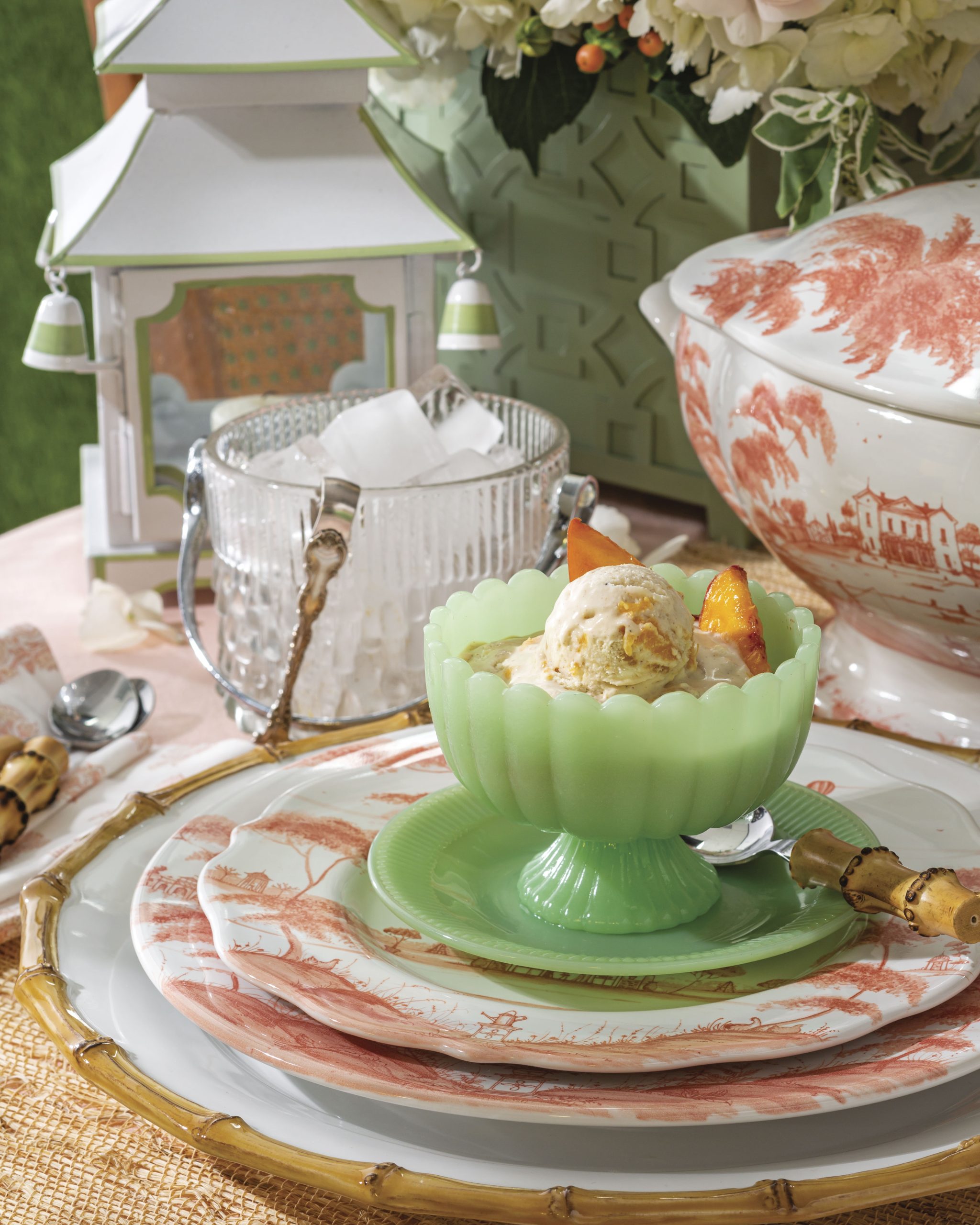 Fresh peach slices top scoops of Peaches Foster Ice Cream.