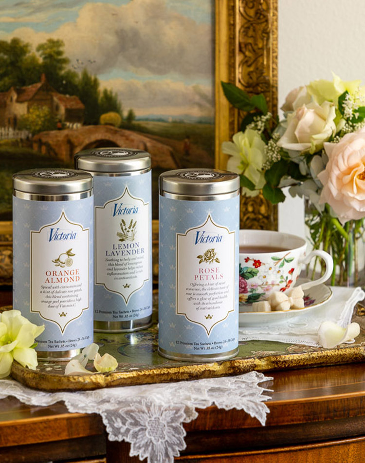An array of Victoria's specialty teas on lace and tray, accompanied by a spring bouquet.