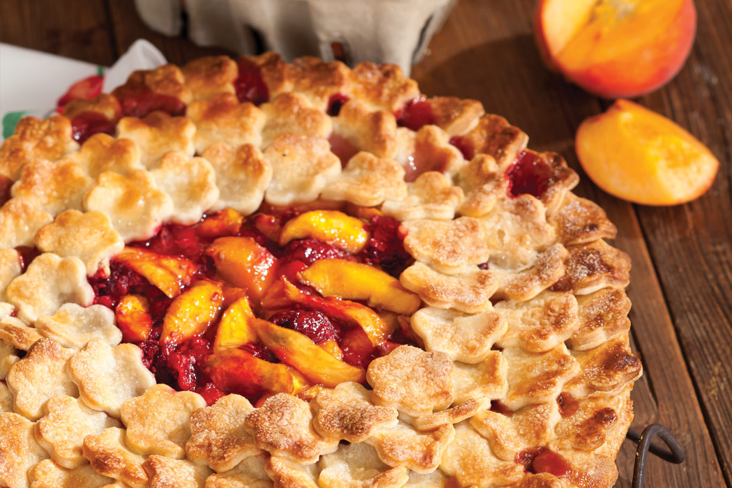 Peach and Raspberry Pie with crust topping shaped like individual flowers.
