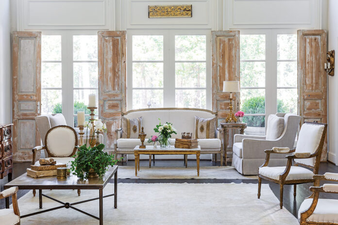 A bright living room expertly combines antique and modern furnishings.
