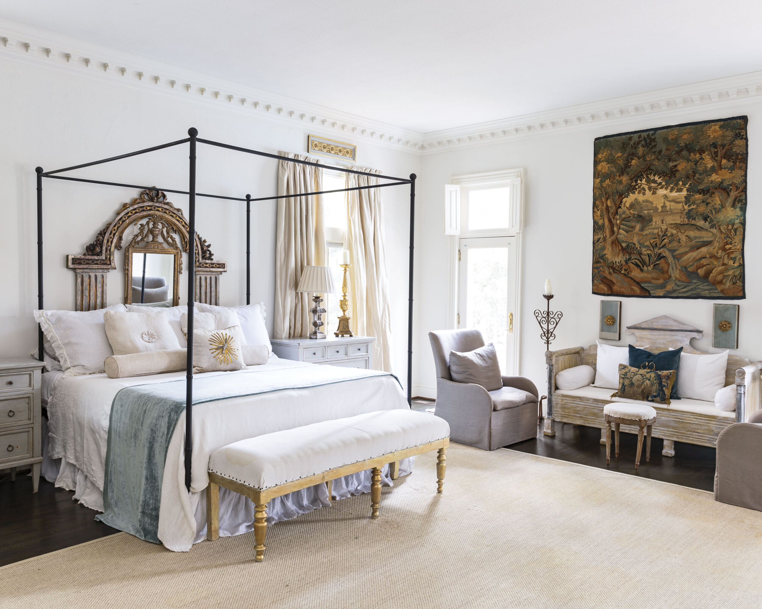 The primary bedroom boasts an array of storied treasures, which mingle nicely alongside newer pieces.