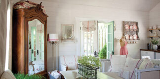 White linen with classic red motifs emblematic of the French country style are prevalent throughout this guest cottage living room.