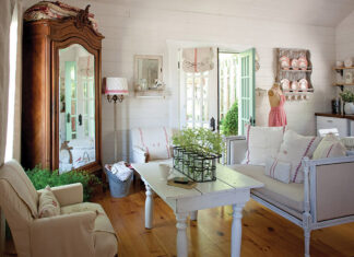 White linen with classic red motifs emblematic of the French country style are prevalent throughout this guest cottage living room.