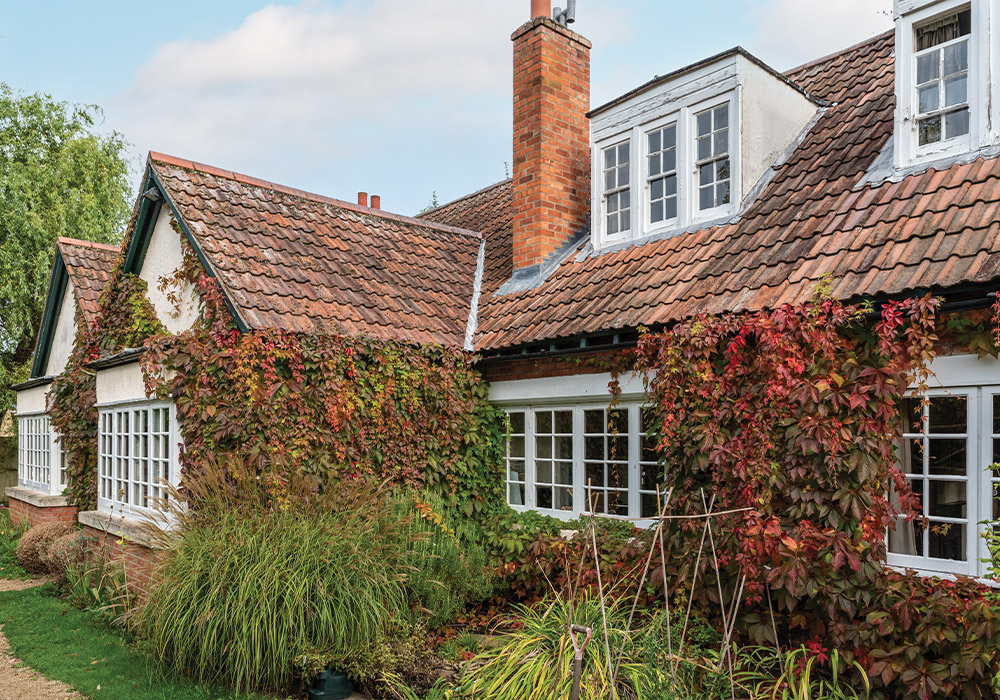 In autumn, warm hues of ivy cover The Kilns, a red brick building where Lewis lived for most of his life.