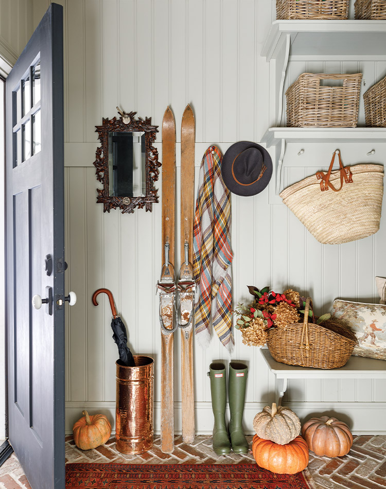 Walking into the doorway of Pantry Hill, one is greeted by a charming scene. A basket of dried hydrangea, pristine pumpkins, boots, and a copper umbrella stand all grace the entryway