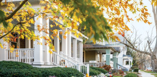 A street view of picturesque houses in Saratoga Springs offers autumnal charm.
