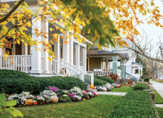 A street view of picturesque houses in Saratoga Springs offers autumnal charm.